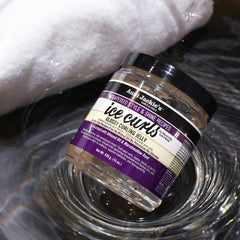 Applying Ice Curls Glossy Jelly to damp hair for defined waves.
