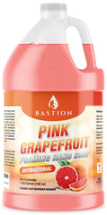 Jabón Bastion espumoso de pomelo rosado en botella, limpieza profunda y fragancia fresca.
