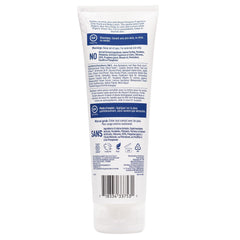 Desert Essence loción textura cremosa en palma, fácil de extender.
