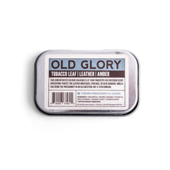 Duke Cannon Old Glory solid cologne tin top showing compact travel tin.