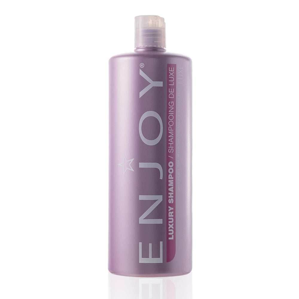 Botella de Enjoy Luxury Shampoo, promueve hidratación y brillo natural.