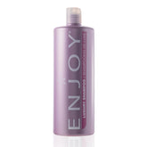 Botella de Enjoy Luxury Shampoo, promueve hidratación y brillo natural.