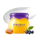 FRUDIA Balsamo labial arándano miel en frasco para hidratación profunda.