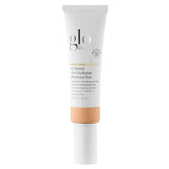 Glo Skin Beauty C-Shield: botella frontal mostrando protección y tono ligero para el día