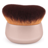 Brocha GloréBrochas Kabuki 75mm con cabeza ovalada para cobertura corporal uniforme.