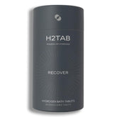 Tableta H2TAB de baño hidrógeno disolviéndose en agua para relajación muscular.