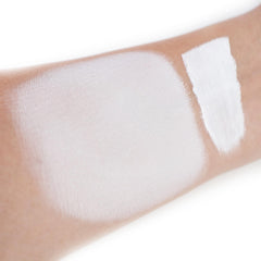IS'MINE white liquid foundation texture on skin showing smooth blending.