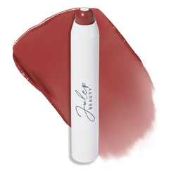 Julep It's Balm Tint Brandy Wine en botella cercana, tono profundo para labios hidratados.