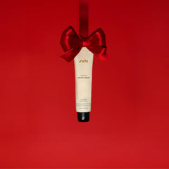 Hands applying JVN No Heat Complete Air Dry Cream for no-heat styling