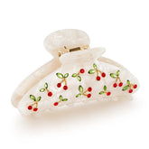 Pinza acrílica LILIE&WHITE con cereza roja y cristales, aporta brillo al peinado
