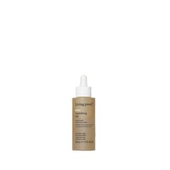 Living Proof No Frizz Vanishing Oil, botella en mano para control del frizz.