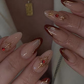 Uñas LPOODDNU adheribles en forma almendra con diseño 3D dorado y diamantes.