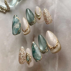 Uñas MINGCHUN con efecto ojo de gato en almendra corta y marmolado 3D para looks elegantes.