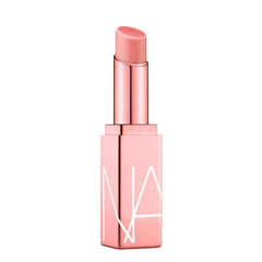 NARS Orgasm Afterglow Lip Balm en envase compacto para hidratación suave.