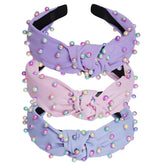 Diadema Sucrain de perlas sintéticas con nudo cruz rosa, look sofisticado.