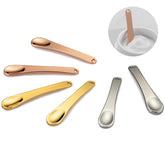 Tekson espátulas cosméticas en rosa-oro para uso facial seguro y limpio.