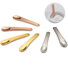 Tekson espátulas cosméticas en rosa-oro para uso facial seguro y limpio.