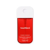 Touchland bruma hidratante para cuerpo y cabello en ámbar dorado, aroma cálido.