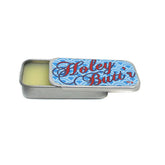 Zaya Holey Butt’r, crema para orejas estendidas, mantiene hidratación y salud del lóbulo.