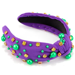 Diadema AHONEY Mardi Gras con nudo central, aporta toque glamoroso al atuendo.
