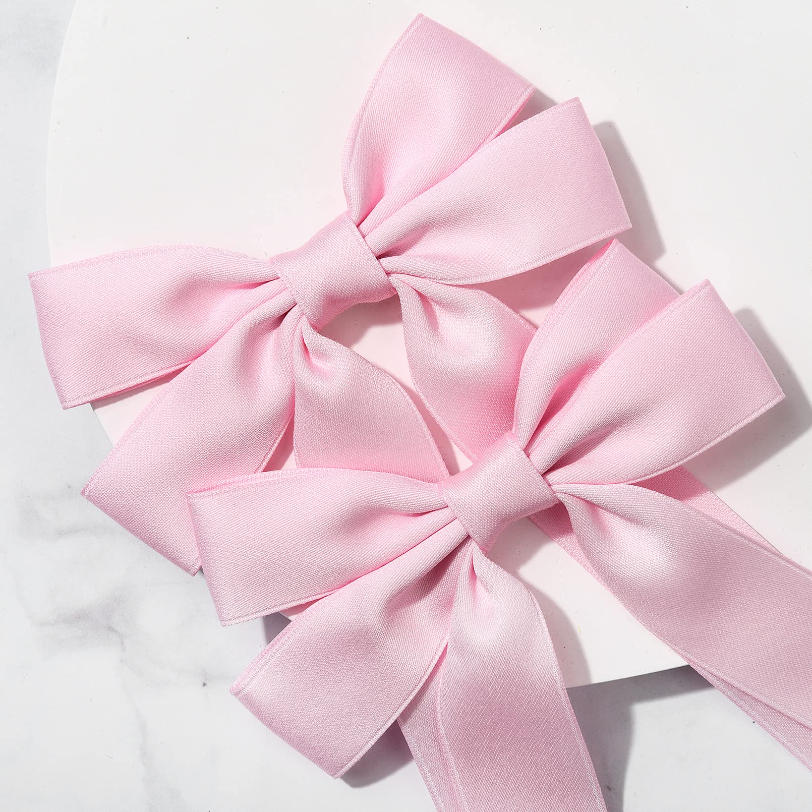 Lazo rosa de Aileam en coleta para un look rápido.