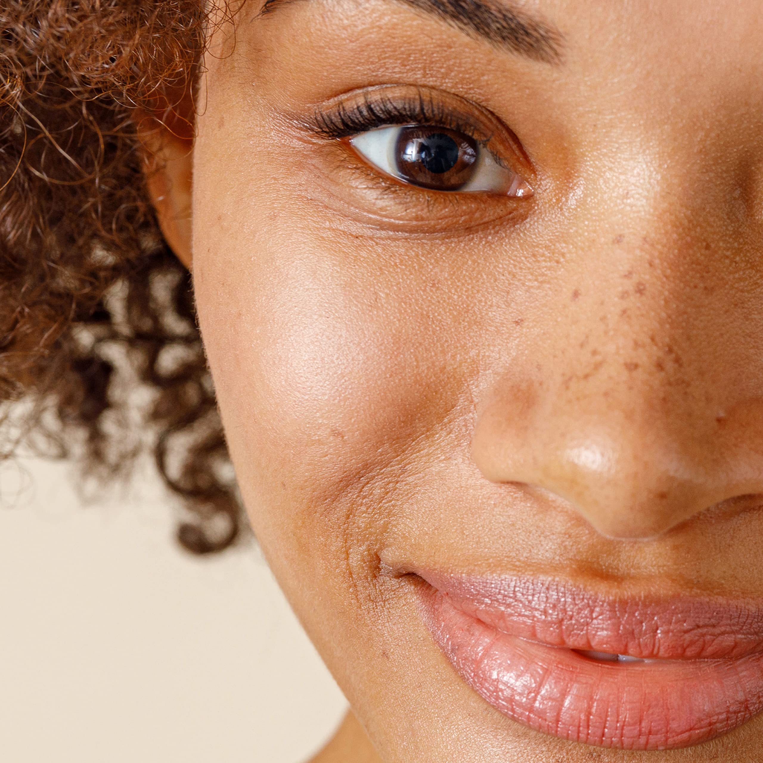 Applying Alpha Renewal Serum to the neck as part of daily care