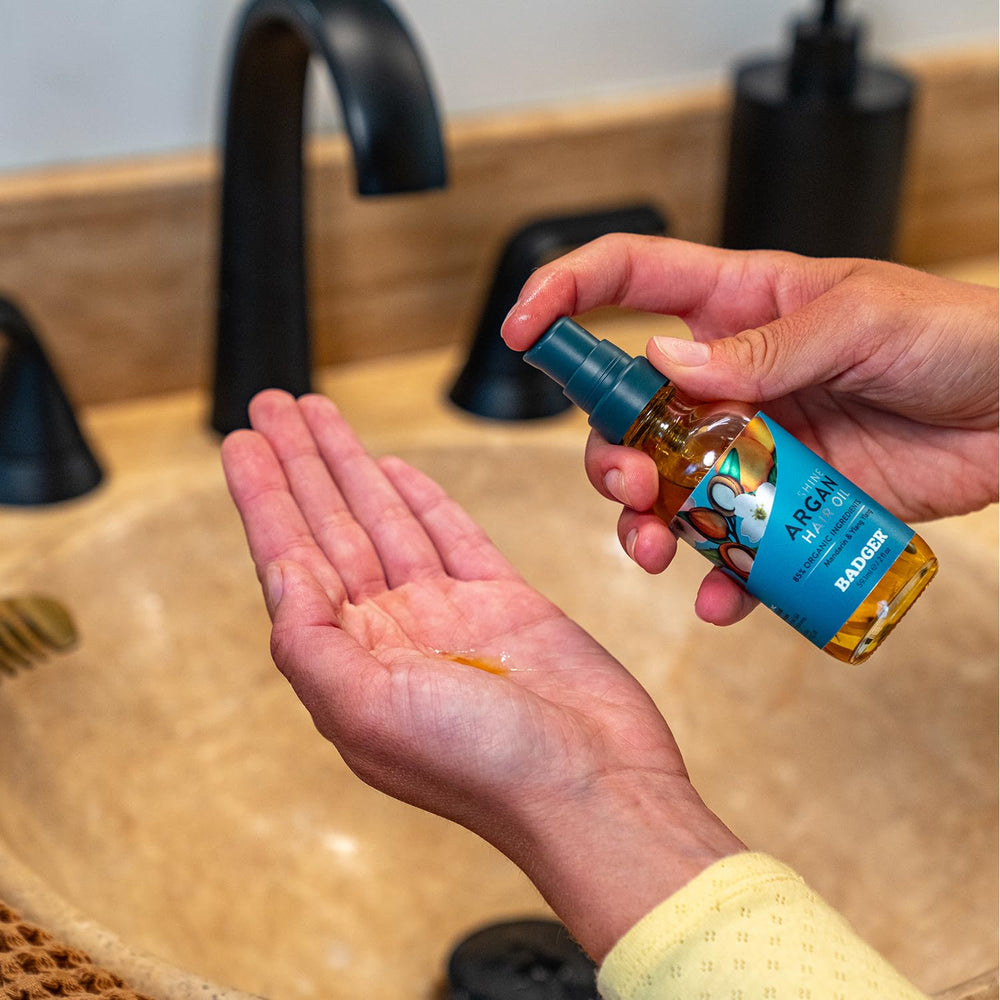 Badger Argan Hair Oil for leave-in conditioning and frizz control.