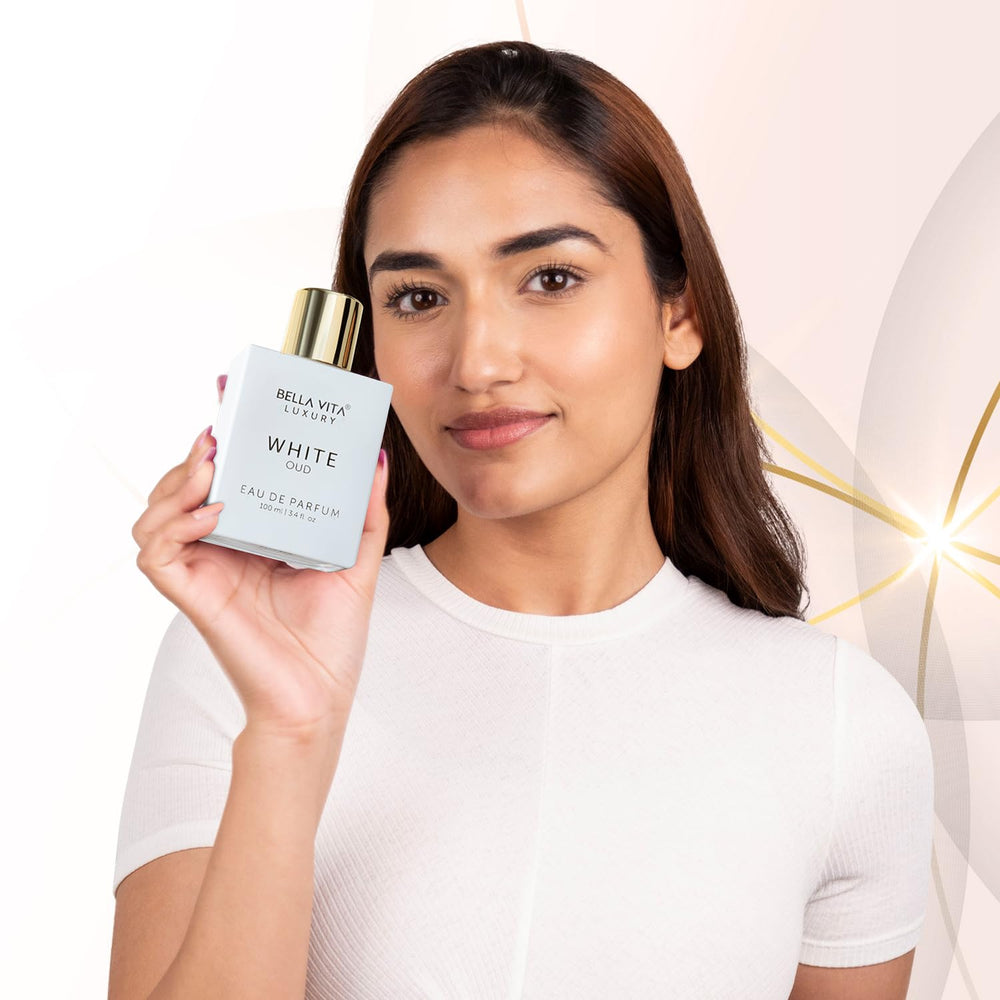 Bella Vita Luxury White Oud, plano cercano de notas oud y vainilla, experiencia aromática envolvente.