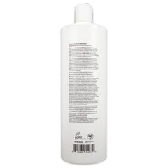 Botella BosRevive en baño, cabello con cuerpo y brillo.