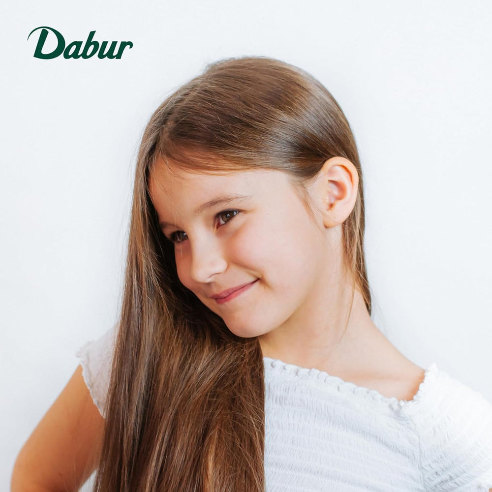 Dabur Amla para niños: ingredientes naturales con aceites de oliva y almendra.