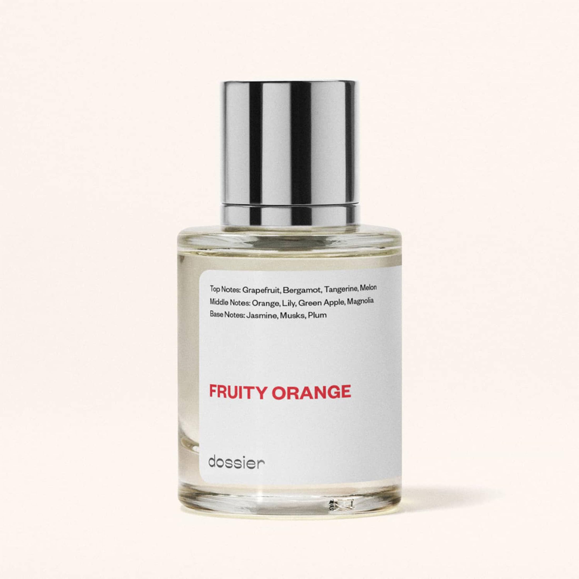 Fragancia Fruity Orange en mano, ideal para viaje.