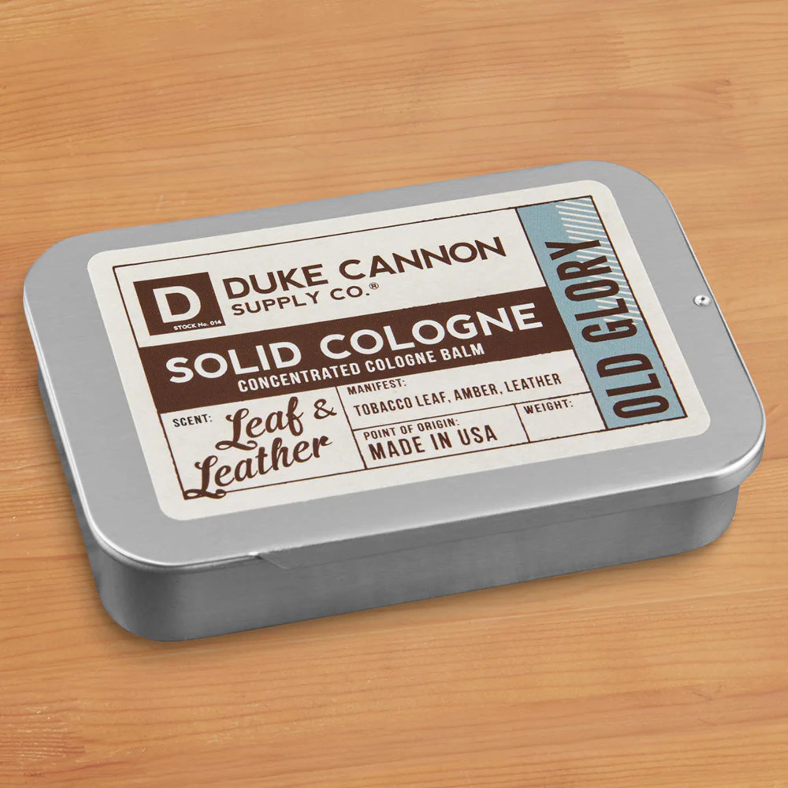 Duke Cannon Old Glory solid cologne being applied to the wrist for precise scent.