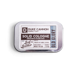 Duke Cannon Old Glory solid cologne tin front, portable fragrance for on-the-go refreshment.