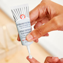 Application en massage de la crème contour des yeux First Aid Beauty pour lisser les ridules.