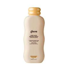 Gisou Honey Gloss Ceramide Therapy Champú: botella derramando, limpieza profunda y fragancia miel silvestre