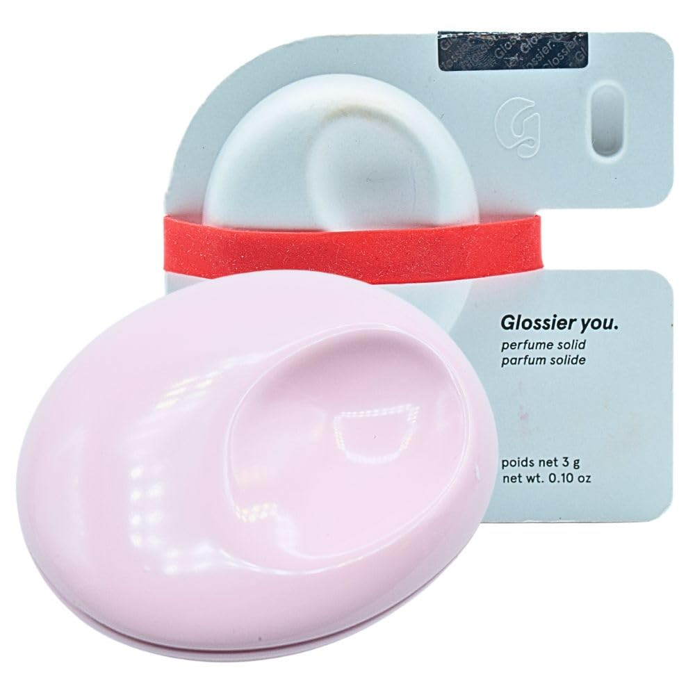 Perfume sólido Glossier You, compacto metálico rosa, uso diario.