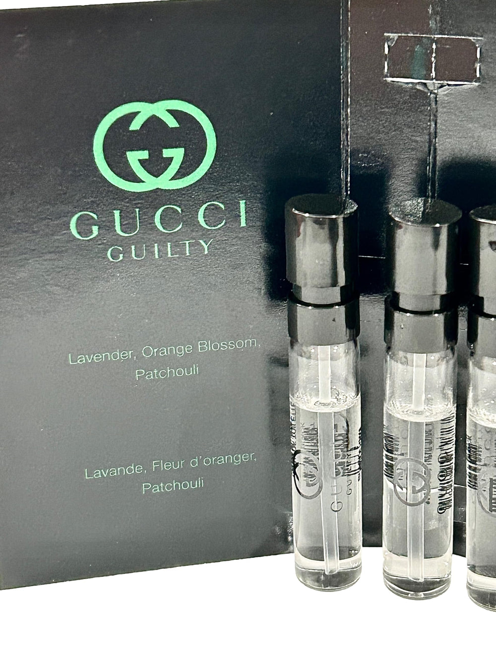 Gucci Guilty Black sample vial close-up, clear label details.