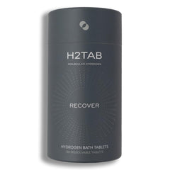 Tableta H2TAB de baño hidrógeno disolviéndose en agua para relajación muscular.