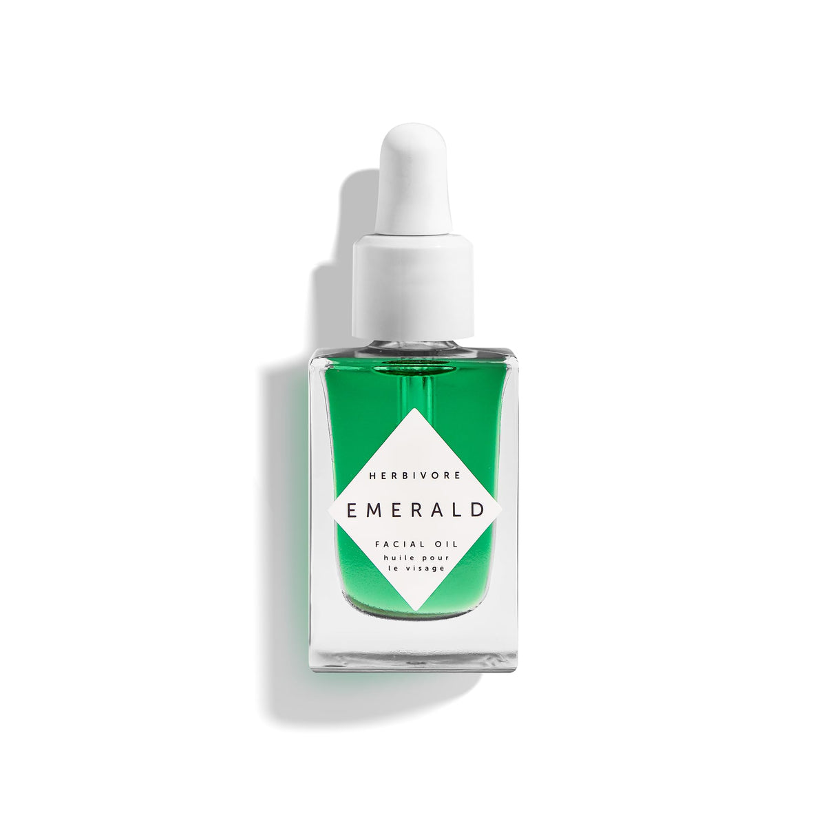 Aceite para rostro HERBIVORE Emerald: botella visible para hidratación suave.