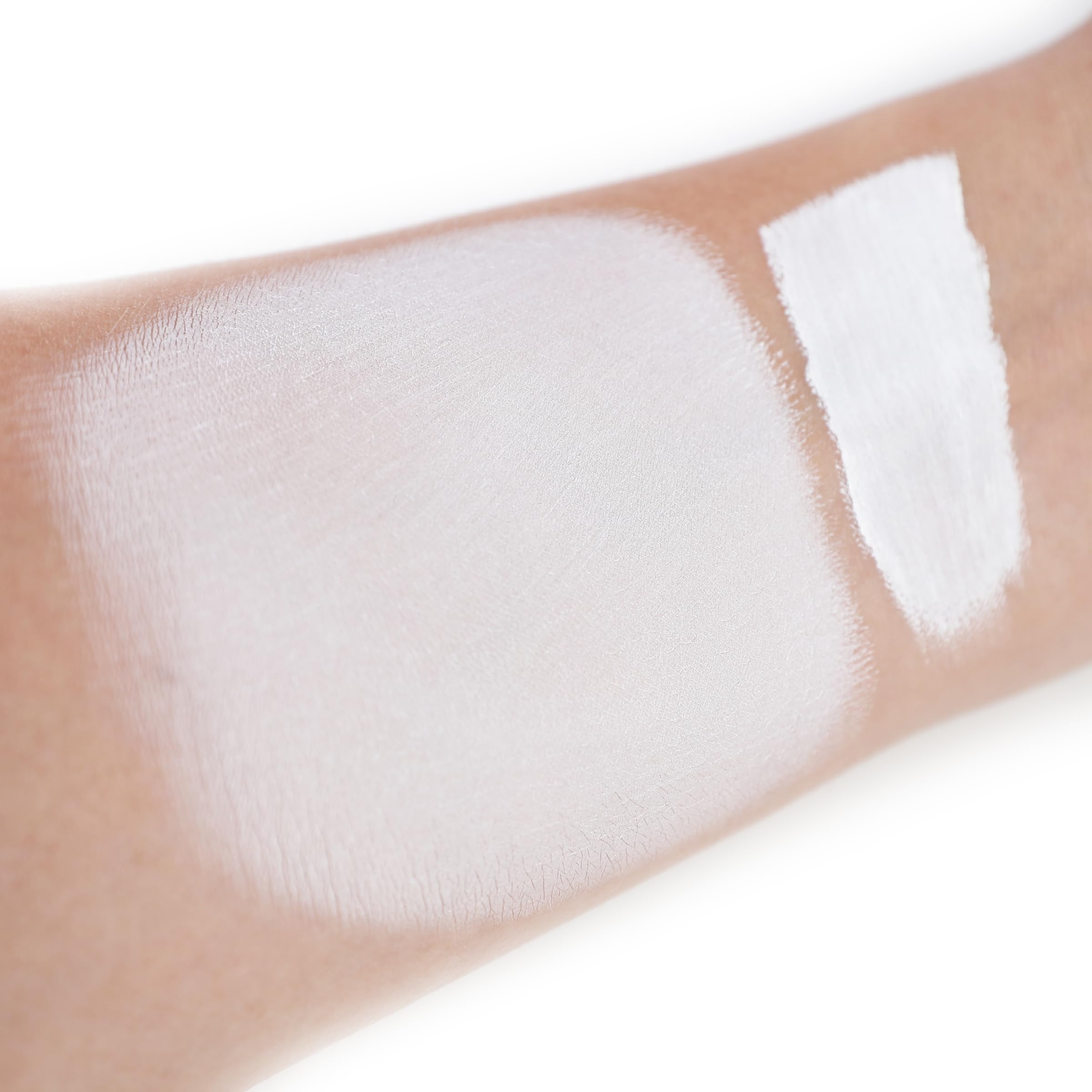 IS'MINE white liquid foundation texture on skin showing smooth blending.