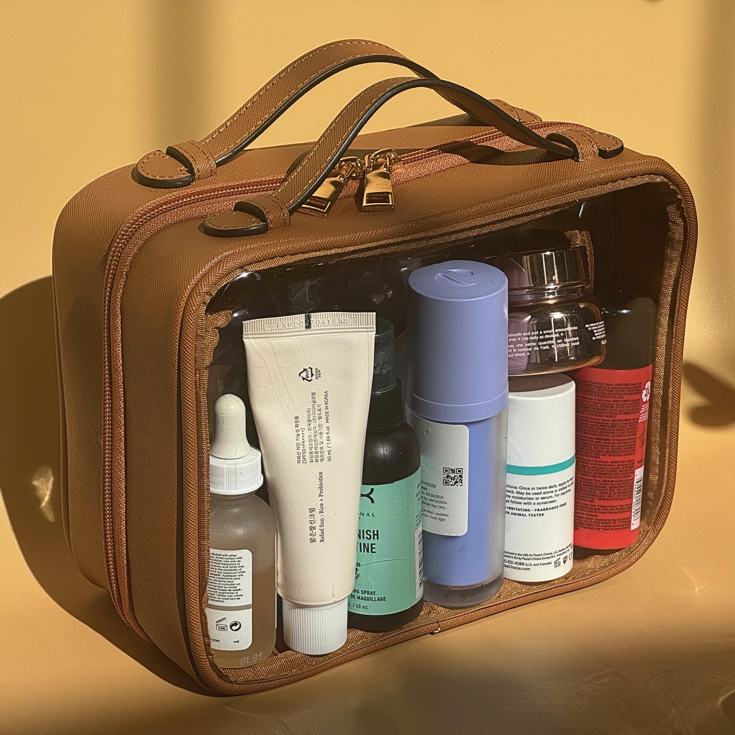 JAZD neceser transparente con doble compartimento para organizar cosméticos y accesorios.