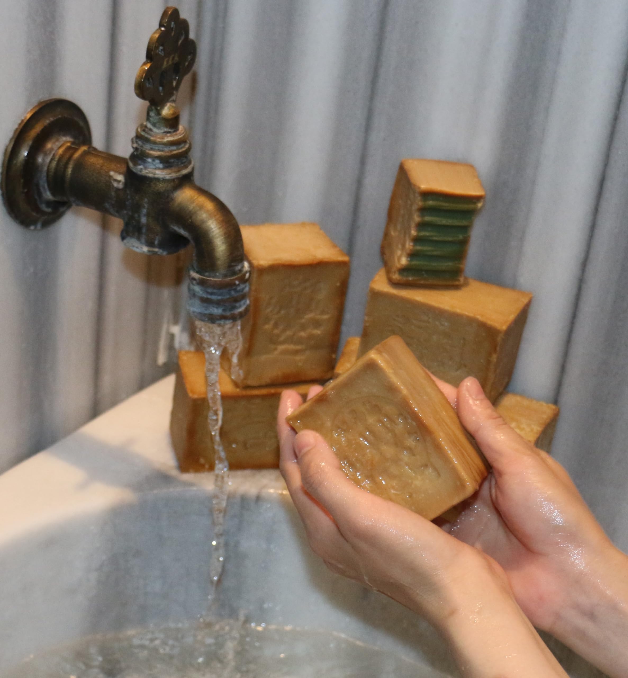 JUSIZA Aleppo Soap used on hands, body, face, and hair care.