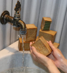 JUSIZA Aleppo Soap used on hands, body, face, and hair care.