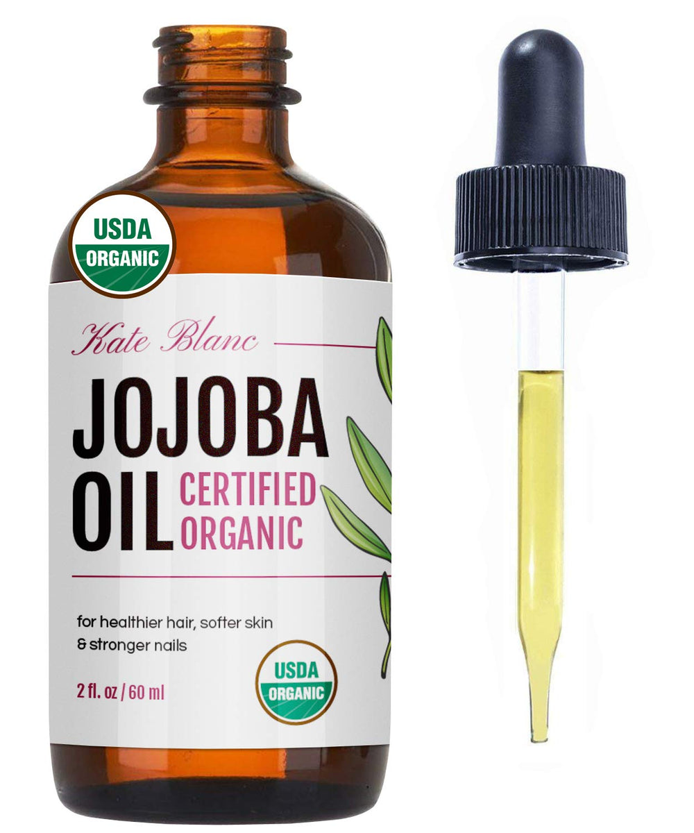 Aceite de Jojoba Kate Blanc: frasco vertido, aplicación suave para piel y cabello.