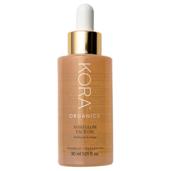 KORA Organics Noni Glow: botella de aceite facial para hidratación suave y brillo natural.
