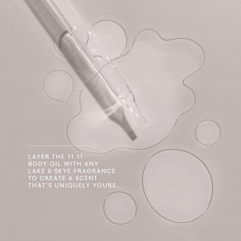 Lake & Skye 11 11 Body Oil Mini dropper in use for massaging into the skin