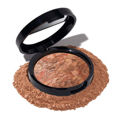 Base profunda de Laura Geller New York para tono Deep con subtono cálido, acabado natural.