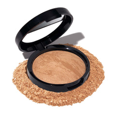 Polvo Balance-n-Brighten en envase de Laura Geller New York, lienzo suave y natural.
