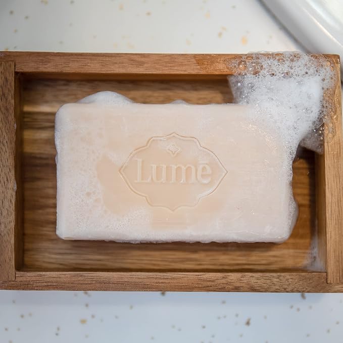 Lume bar soap in hand showing gentle cleansing action