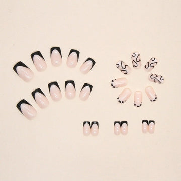 Maigitur uñas acrílicas negras con acabado brillante y diseño de corazón